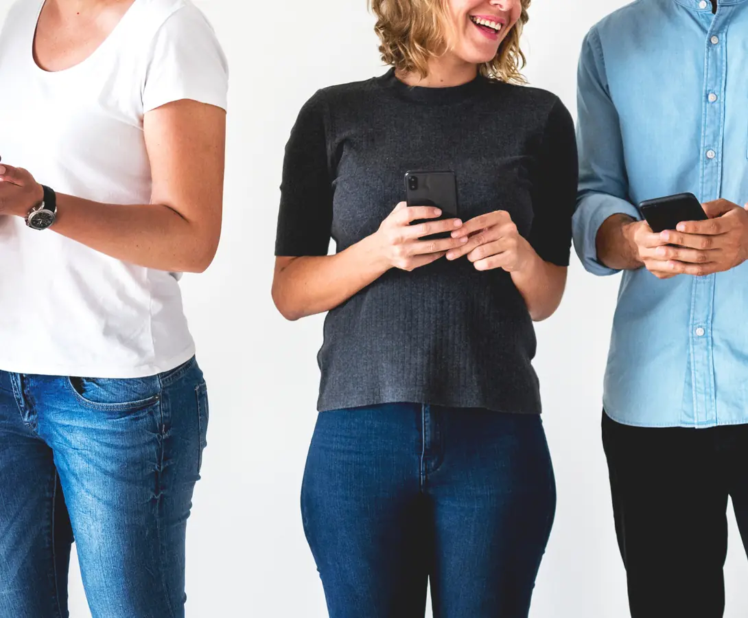 A lineup of people using their phones